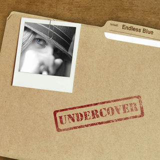 A folder with the title "Undercover" typed on the tab with a photo of Endless Blue singer Laura Hillman cliped to the outside.