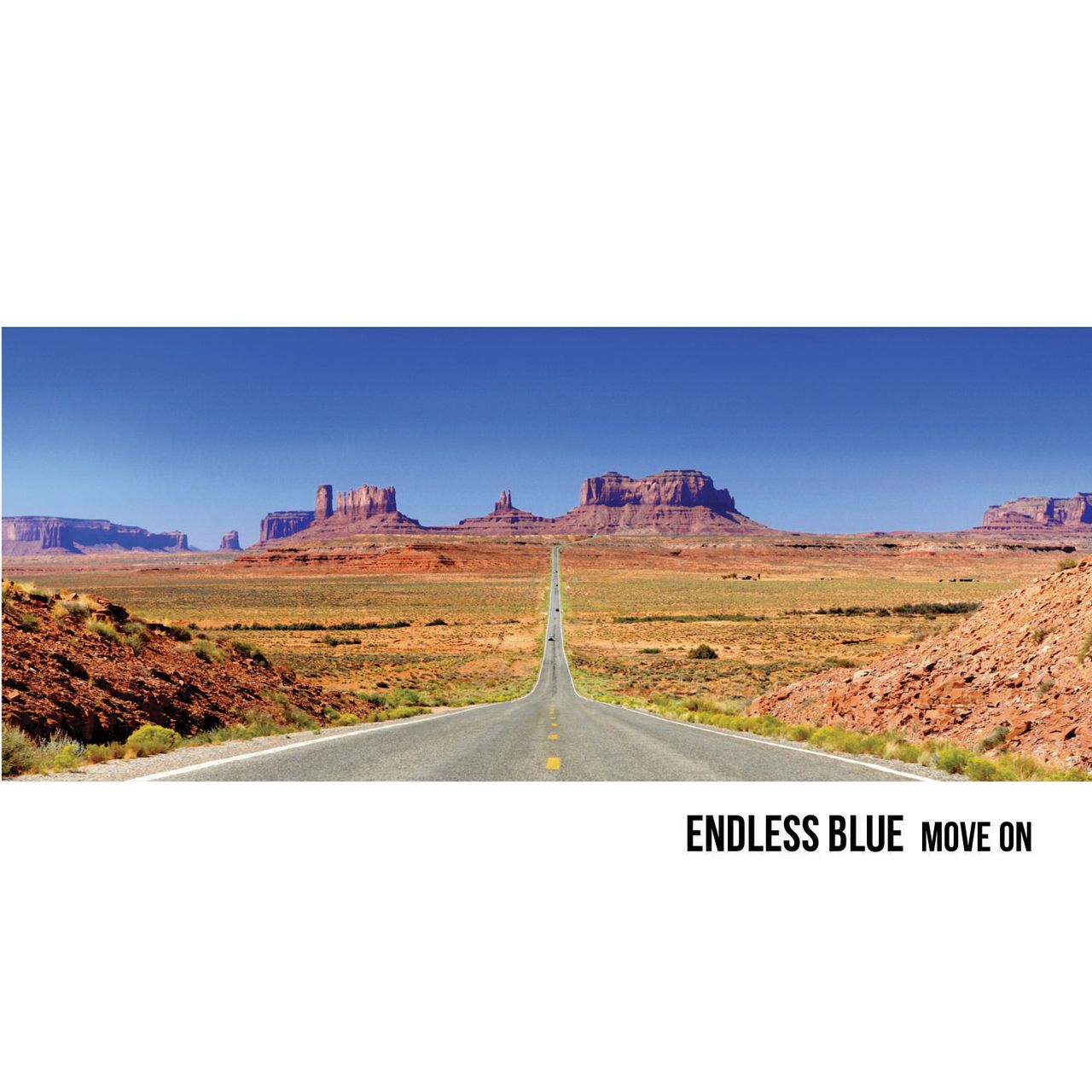 A road leading into a desert scene in the distance.