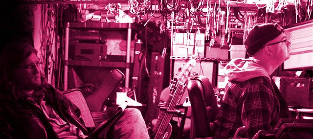 Singer and songwriter Graham Killeen and producer Nick Mitchell sit in Buffalo Bill’s Basement Studio working on tracks.